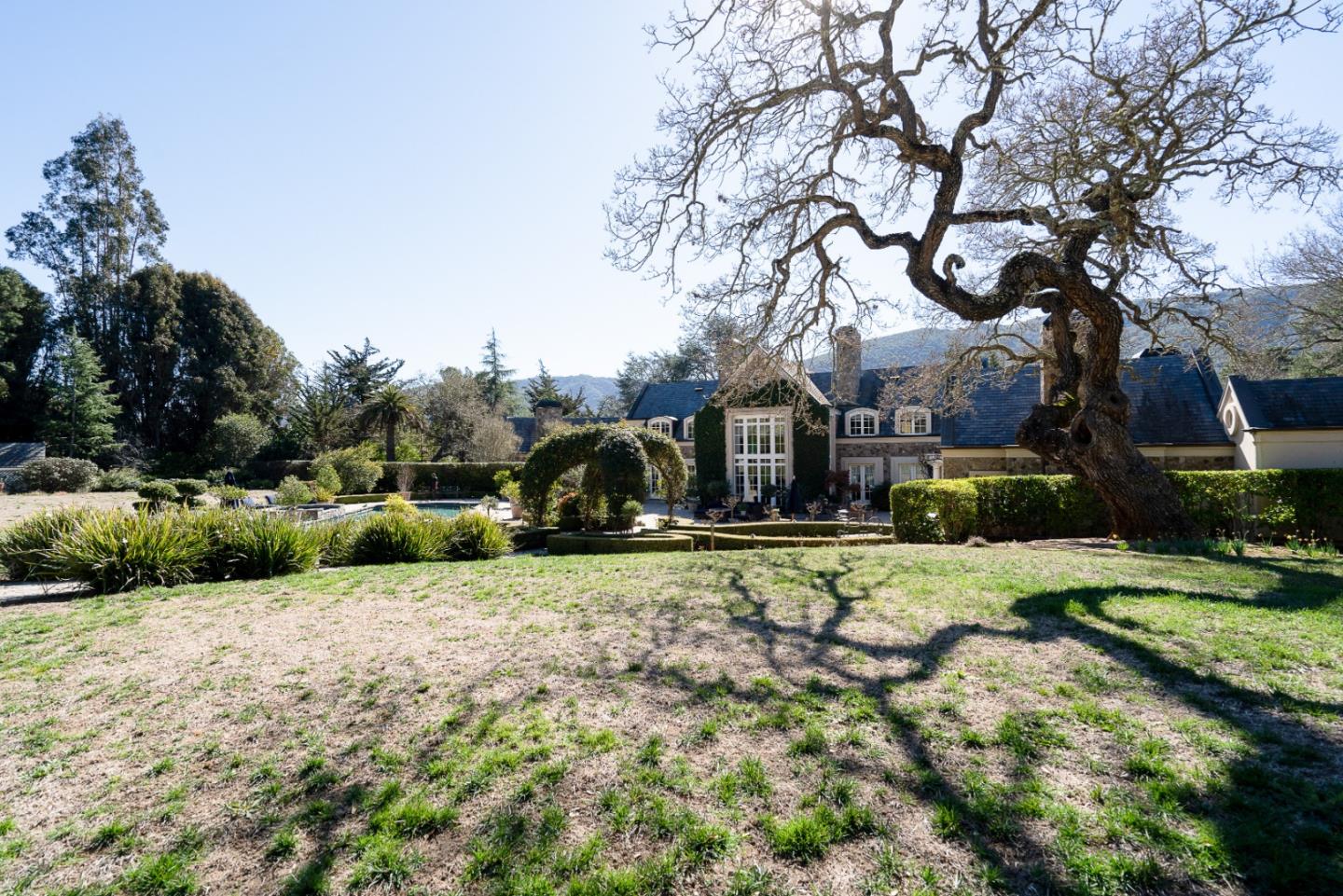 12 Ring Lane Carmel Valley, CA 93924 - Photo 59 of 73 a yellow house sitting in middle of the middle of a yard