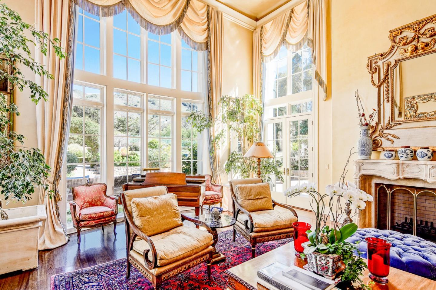 12 Ring Lane Carmel Valley, CA 93924 - Photo 8 of 73 a living room with furniture a fireplace and a floor to ceiling window