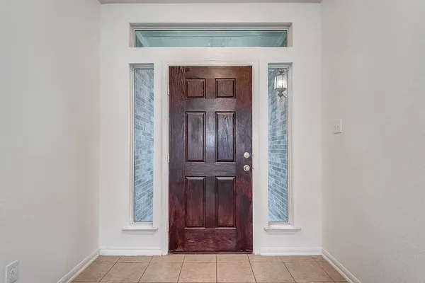 wooden floor in a room with a chandelier fan