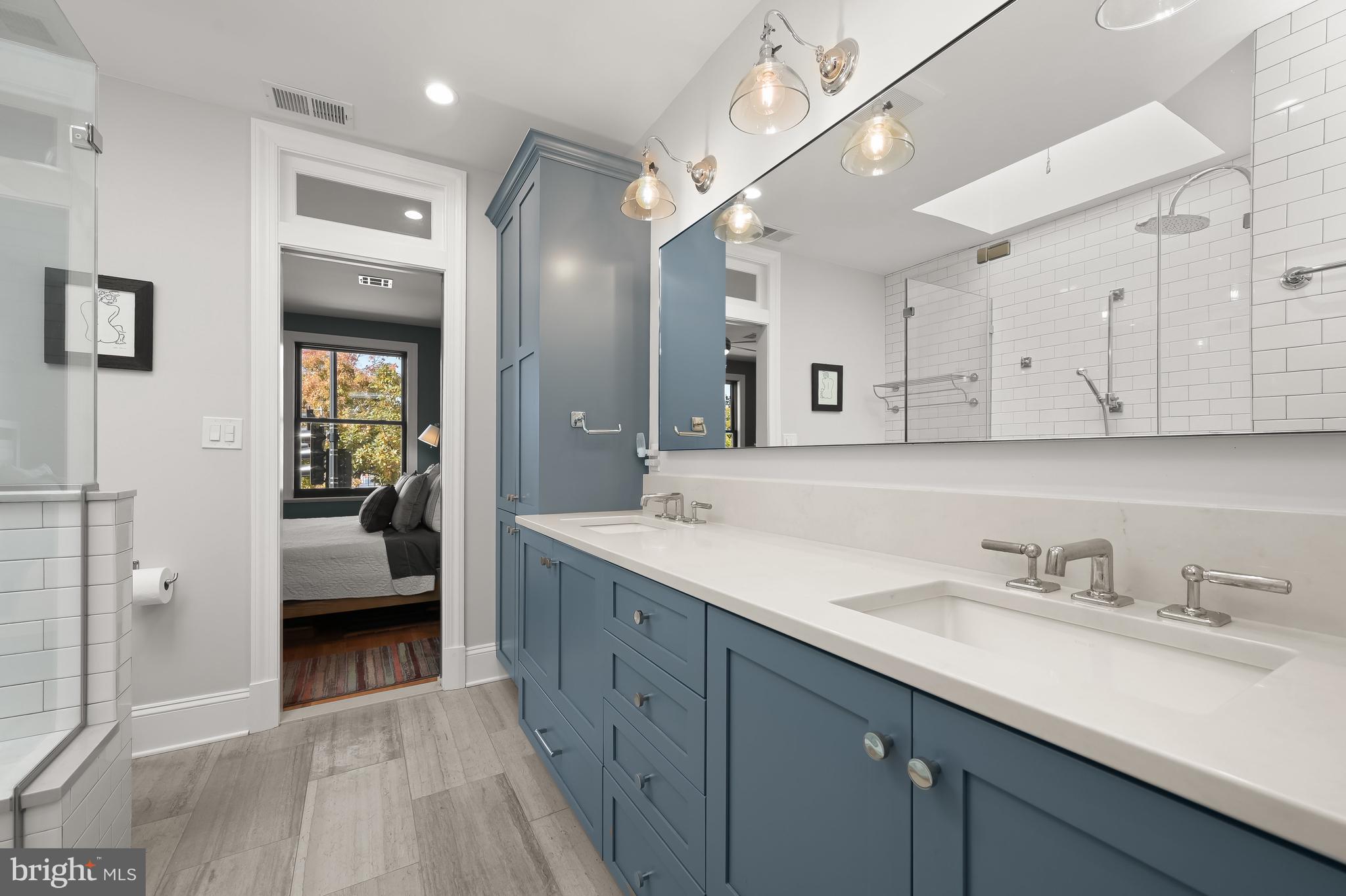 1733 11th Street Northwest Washington, DC 20001 - Photo 12 of 21 a spacious bathroom with a double vanity sink and a mirror