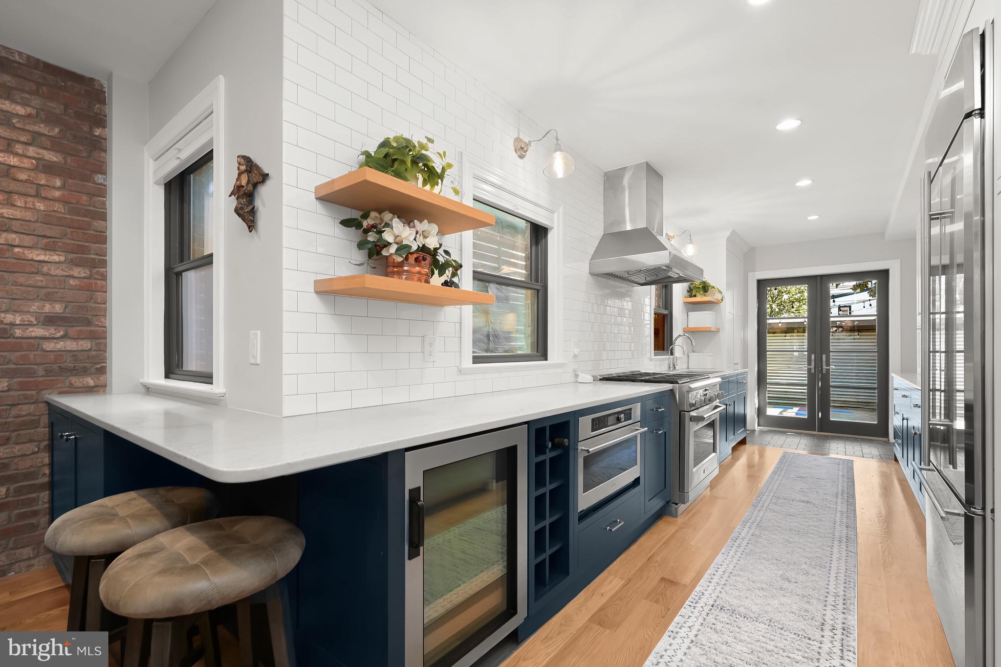 1733 11th Street Northwest Washington, DC 20001 - Photo 7 of 21 a kitchen with stainless steel appliances kitchen island a large island in the kitchen