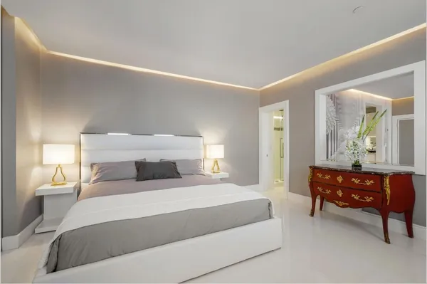 a bedroom with a bed and a dresser in it