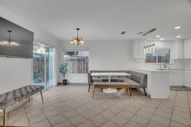 a room with furniture pool table and window