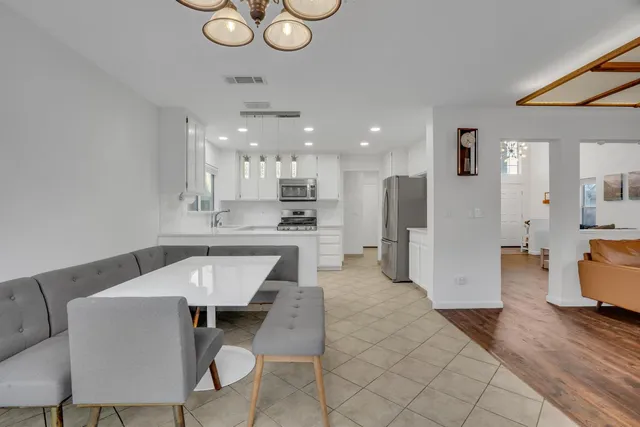 a kitchen with stainless steel appliances kitchen island granite countertop a sink and cabinets
