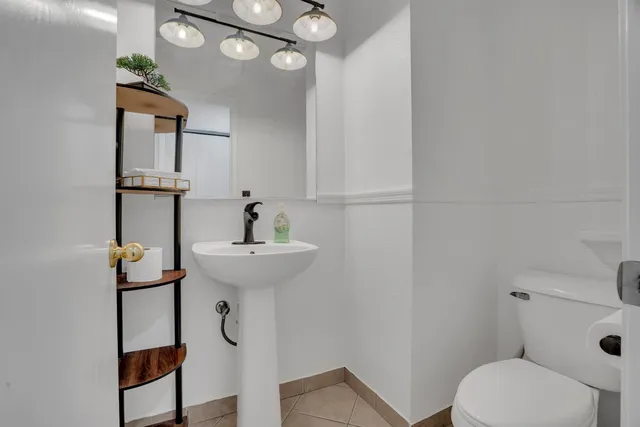 a bathroom with a sink a toilet and mirror