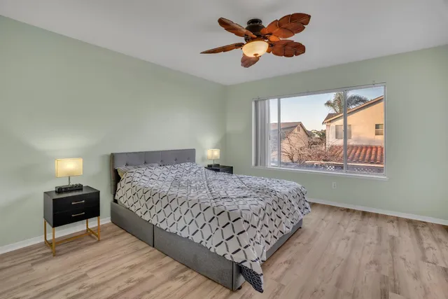 a bedroom with a bed and a painting on the wall