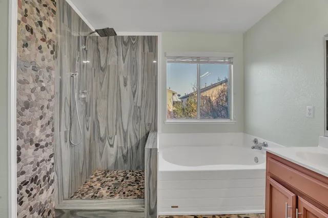 a bathroom with a bathtub and shower