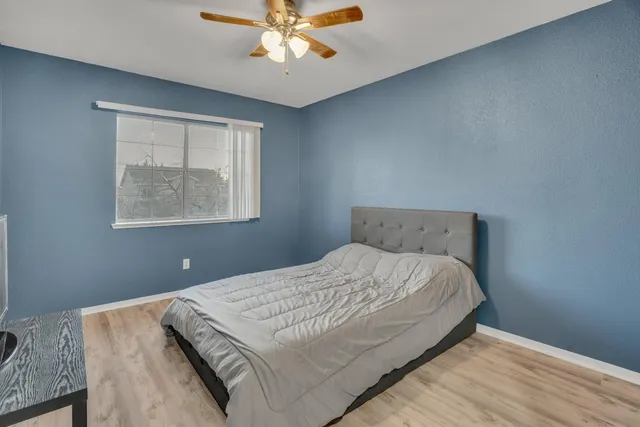 a bedroom with a bed and a chandelier