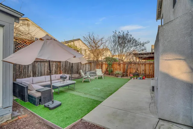 a view of a house with backyard and sitting area