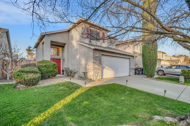 a view of a house with a yard and sitting area