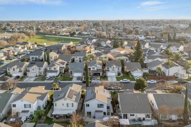a view of a house with backyard and sitting area
