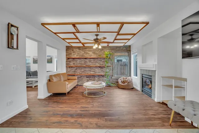a living room with furniture large window and flat screen tv