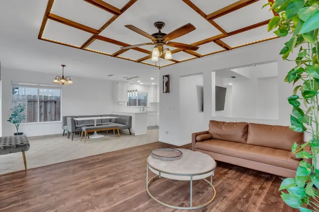 a living room with furniture and a chandelier