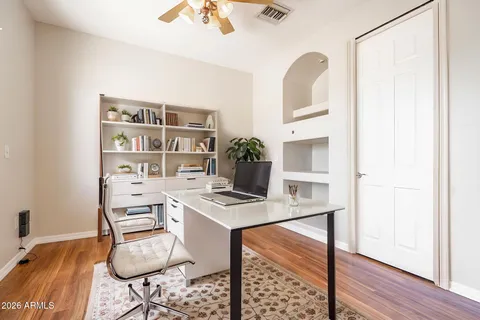 an empty room with a hardwood and wooden floor
