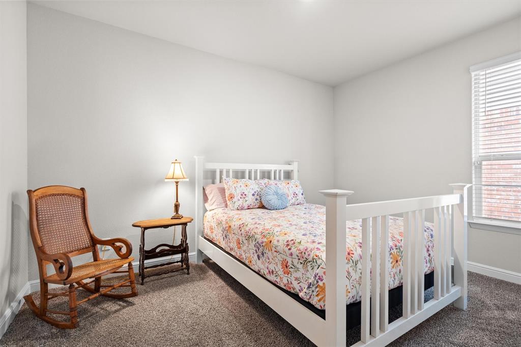 1864 Mensa Drive Haslet, TX 76052 - Photo 32 of 40 a bedroom with a bed and chair