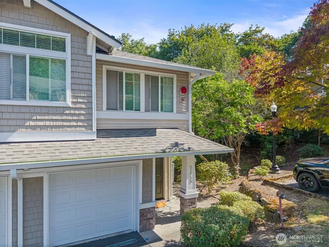 an aerial view of a house with a garden and lake view