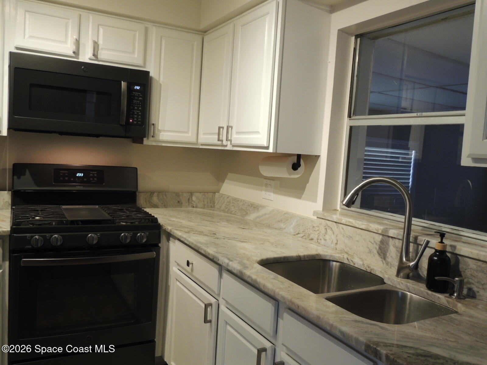 1312 Huntington Lane Rockledge, FL 32955 - Photo 6 of 21 a kitchen with a sink stove and microwave