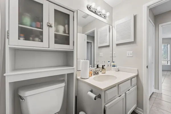 a bedroom with a bed and a ceiling fan