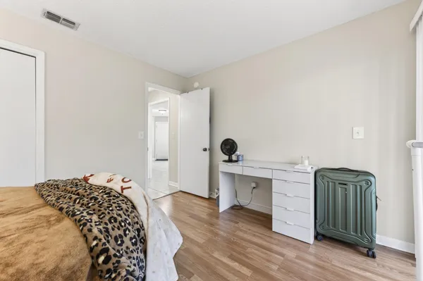 a bedroom with a bed and wooden floor