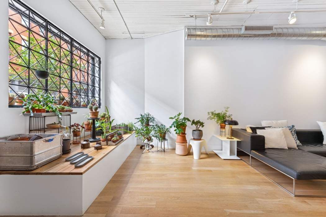 a living room with furniture and flowers