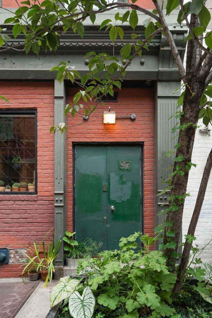 97 Crosby Street, Unit 1 Manhattan, NY 10012 - Photo 10 of 15 a front view of a house with garden
