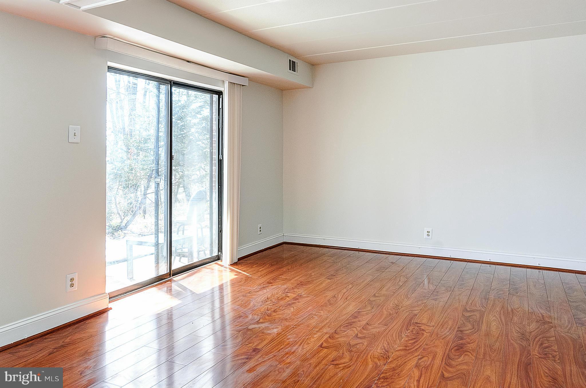 6260 Edsall Road, Unit 101 Alexandria, VA 22312 - Photo 4 of 30 Living Room with ground level patio