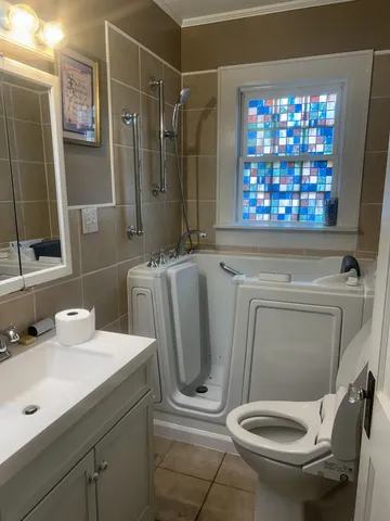a bathroom with a toilet sink and mirror