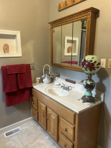 a bathroom with a sink and a mirror
