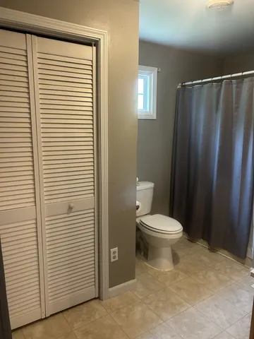 a white toilet sitting next to a bathroom sink