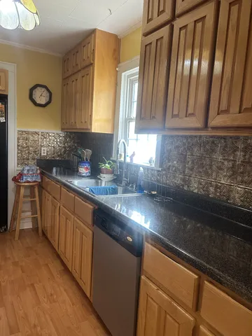 a kitchen with granite countertop a sink and a stove