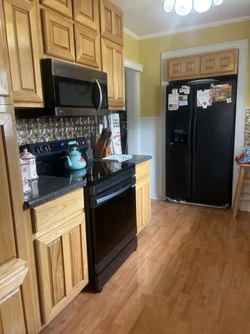 a kitchen with granite countertop a stove and a microwave