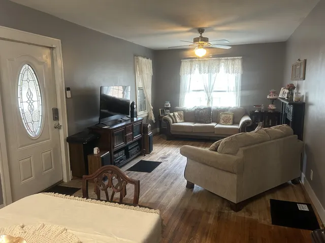 a living room with furniture a large window and a flat screen tv