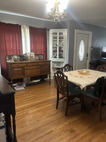a room with a table chairs and entryway