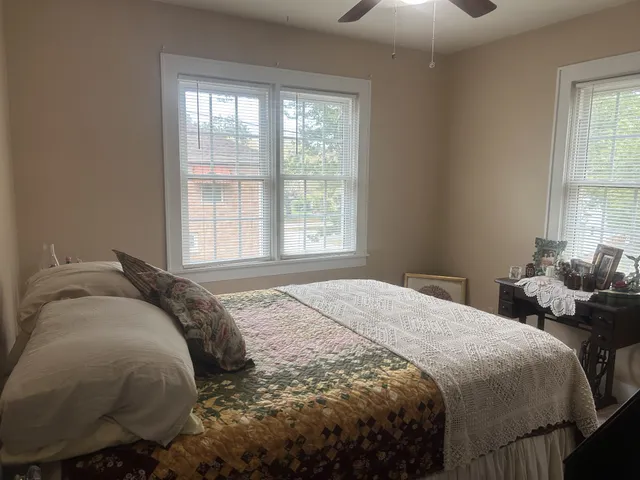 a bed sitting in a bedroom next to a window