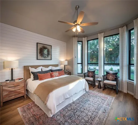 a bedroom with a large bed and a large window