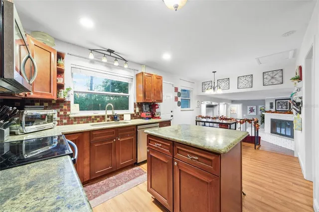 a kitchen with stainless steel appliances granite countertop a stove and a sink