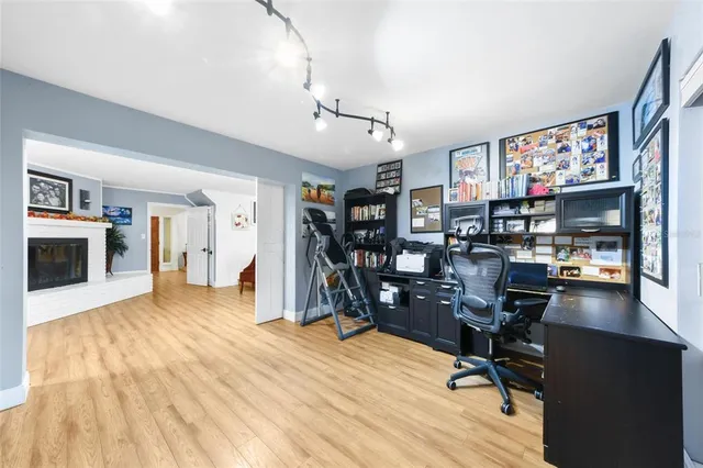 a view of a workspace with furniture and a window