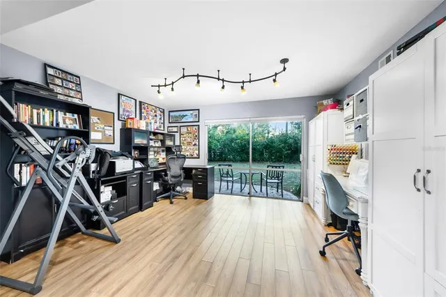 a view of a livingroom with furniture staircase and a floor to ceiling window