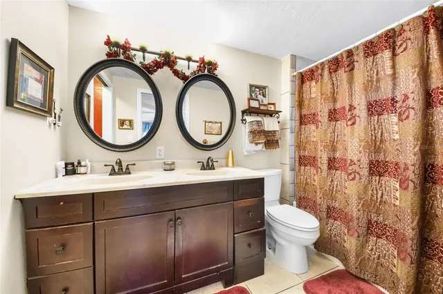 a bathroom with a toilet a sink and a mirror