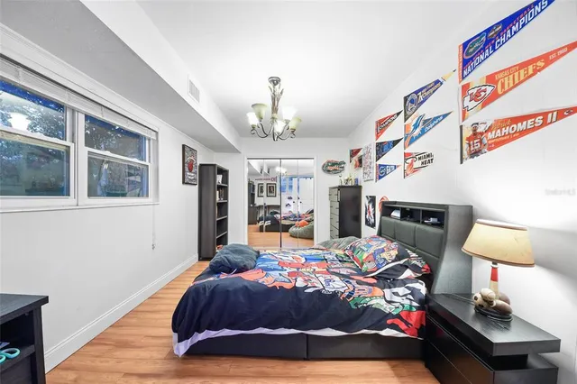 a bedroom with a bed dresser and a window