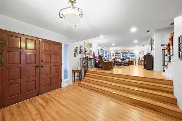 a bedroom with a bed and closet with wooden floor