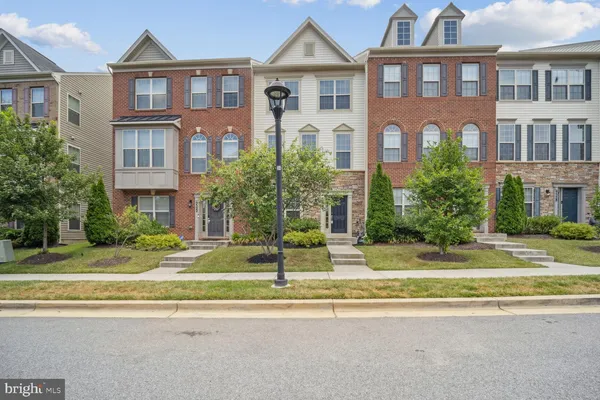 a front view of a residential apartment building with a yard