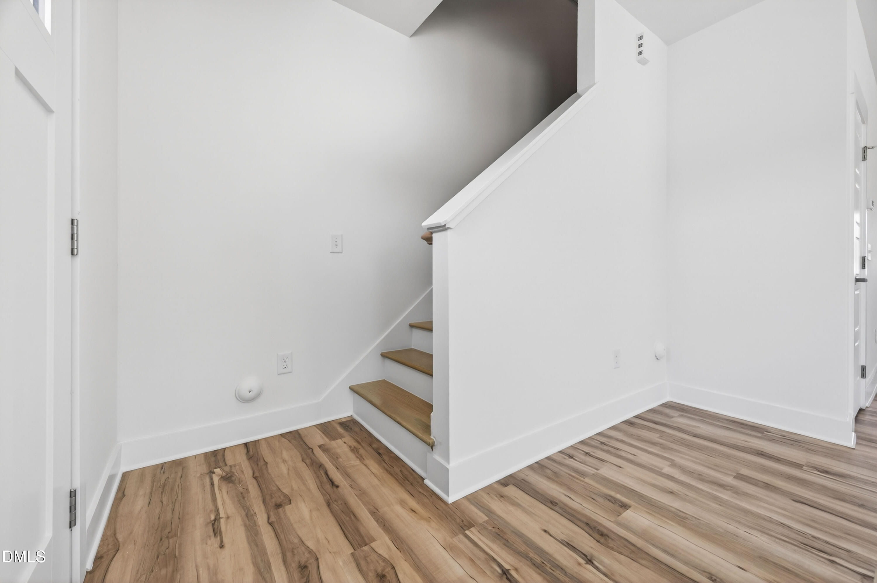 1256 Hurdle Mills Road Roxboro, NC 27573 - Photo 24 of 48 a view of a room with wooden floor and white walls
