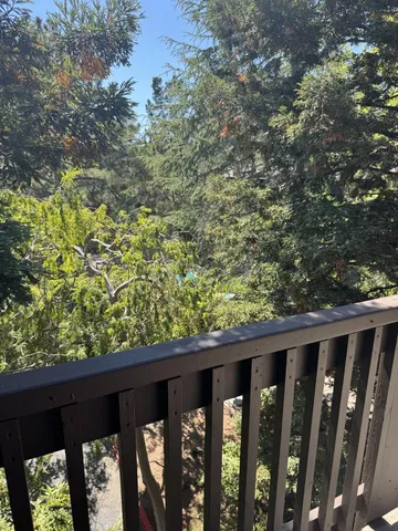 a wooden fence with trees in the background