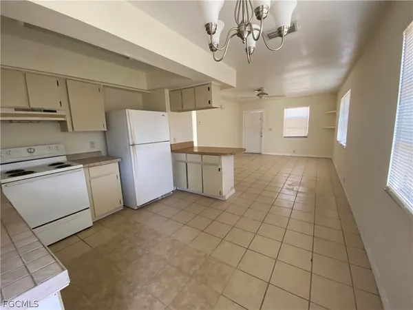a view of a kitchen with a sink cabinets and stainless steel appliances