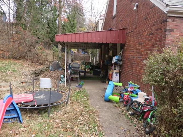 a front view of house with yard outdoor seating and barbeque oven
