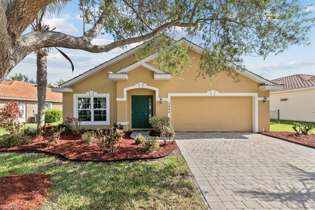2806 Orange Grove Trail Naples, FL 34120 - Photo 1 of 24 a front view of a house with yard and green space