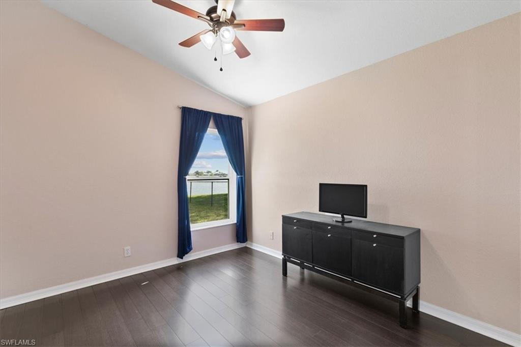 2806 Orange Grove Trail Naples, FL 34120 - Photo 12 of 24 a view of an empty room with a window and wooden floor