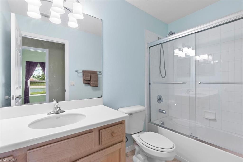 2806 Orange Grove Trail Naples, FL 34120 - Photo 14 of 24 a bathroom with a sink a toilet a mirror and shower