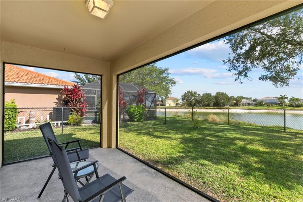 2806 Orange Grove Trail Naples, FL 34120 - Photo 16 of 24 a view of a chairs and table in patio with a lake view